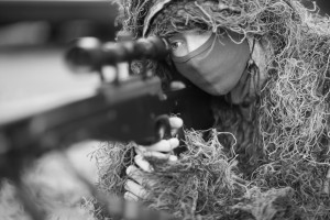 Closeup portrait of a sniper in camouflage